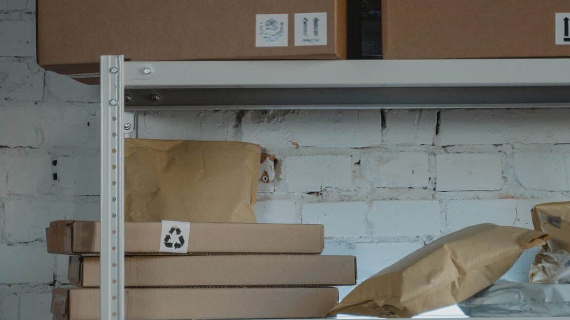 Stacked brown cardboard shipping boxes on steel warehouse shelves ready for order fulfillment