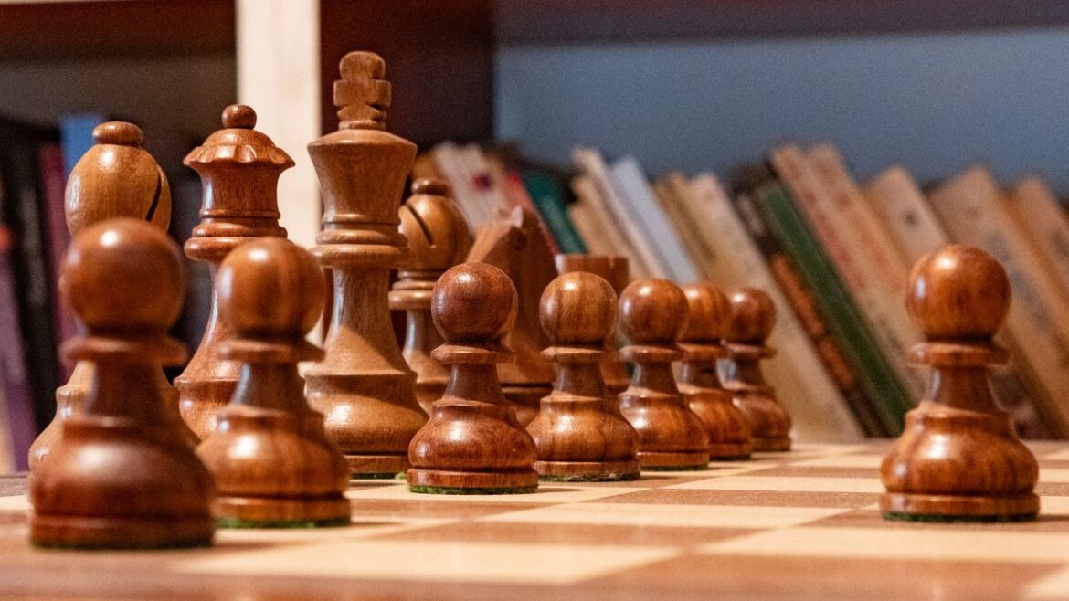 Wooden chess pieces lined up on a chessboard representing strategy and controlled decisions