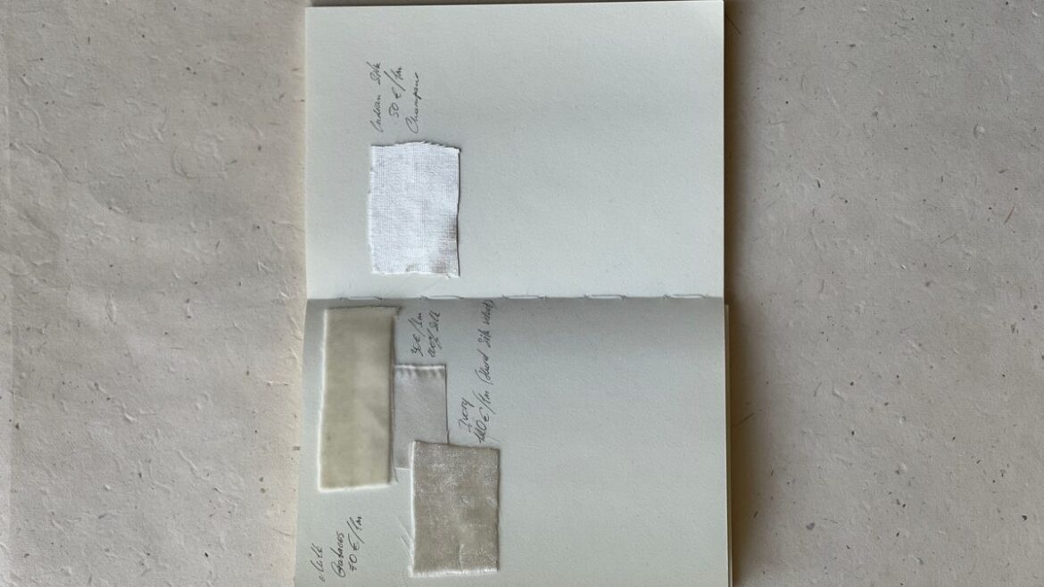 Top view of an open journal with handwritten notes recording entries on a neutral background